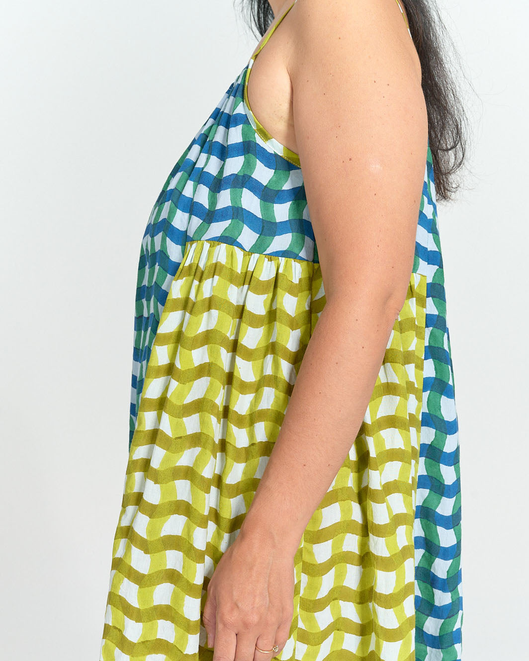 Detail of gathered side panel and blue and green wavy stripe fabric