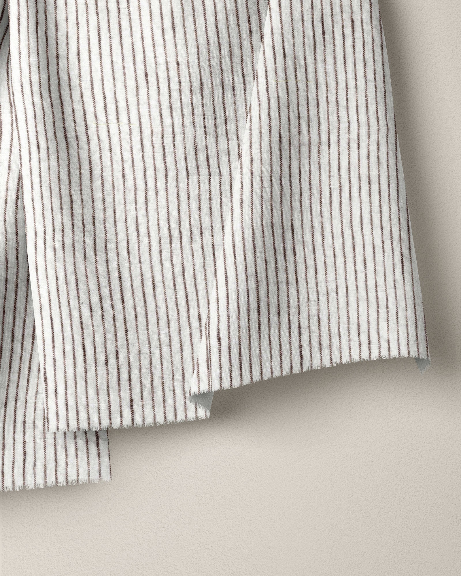 Close-up of a striped fabric with black and white lines on a beige background