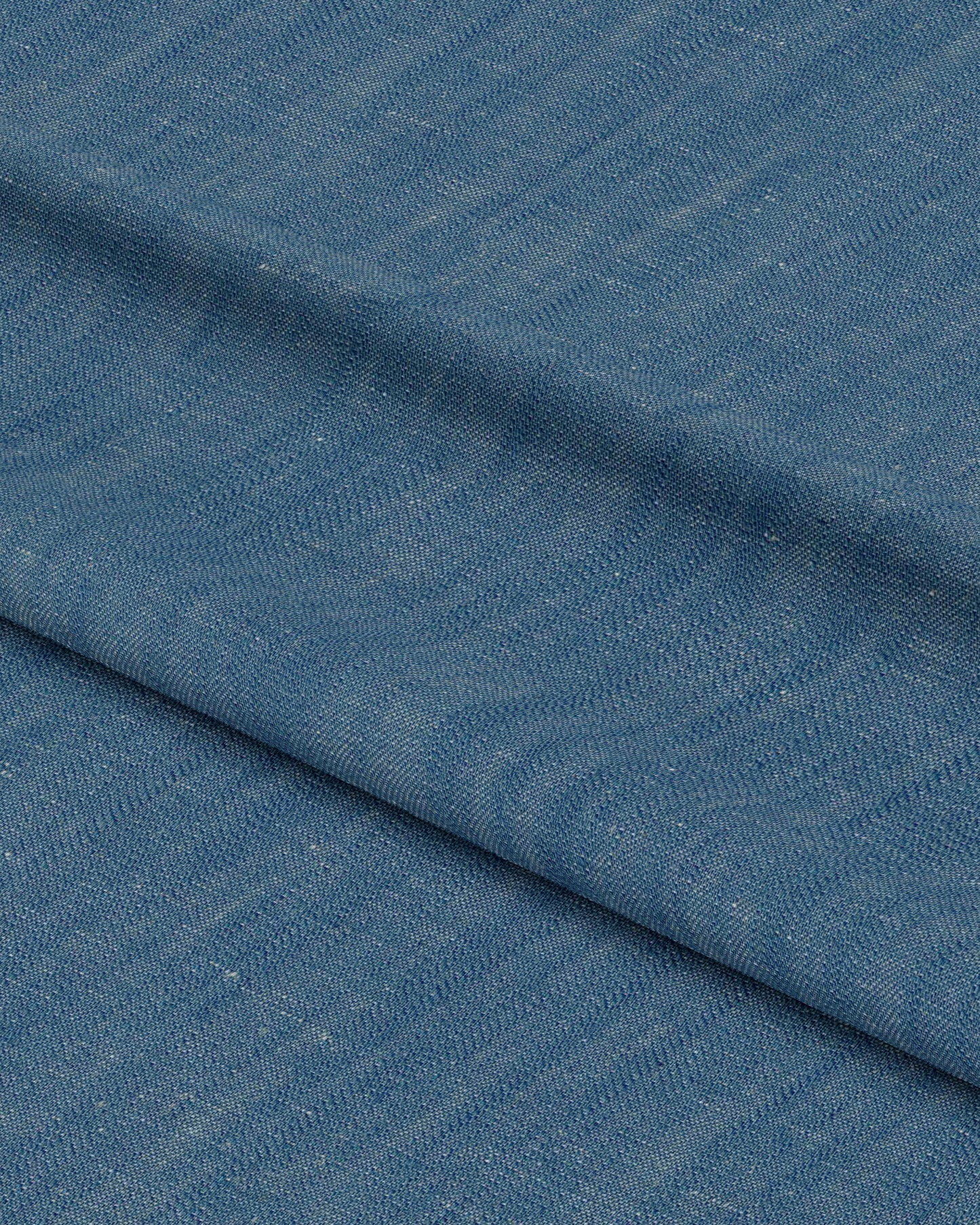 Close-up of blue fabric with a subtle pattern