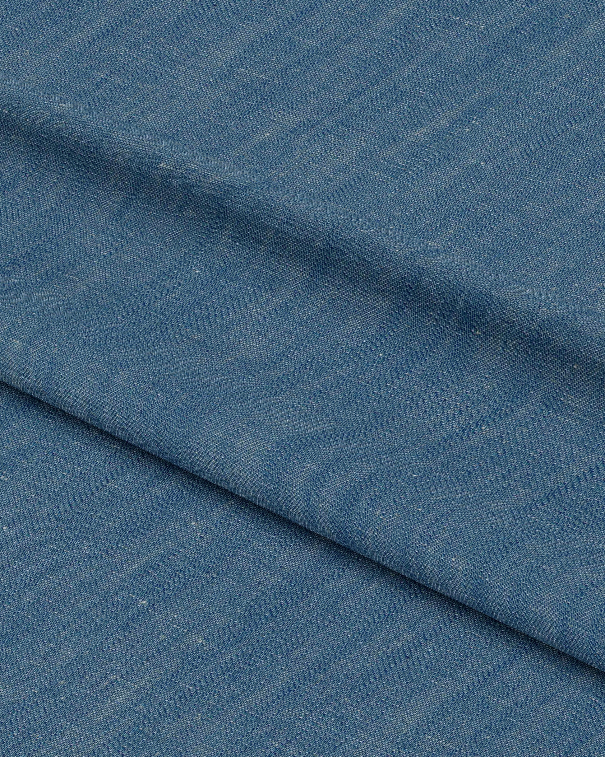 Close-up of blue fabric with a subtle pattern