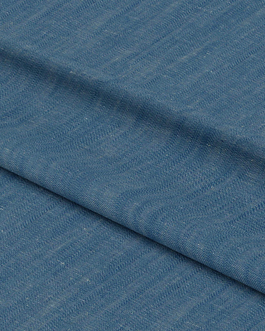 Close-up of blue fabric with a subtle pattern