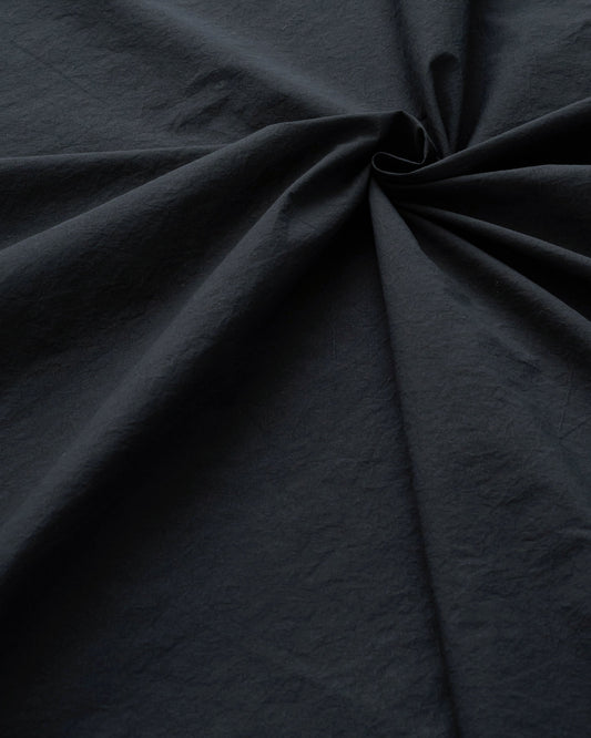 Close-up of dark gray fabric with folds