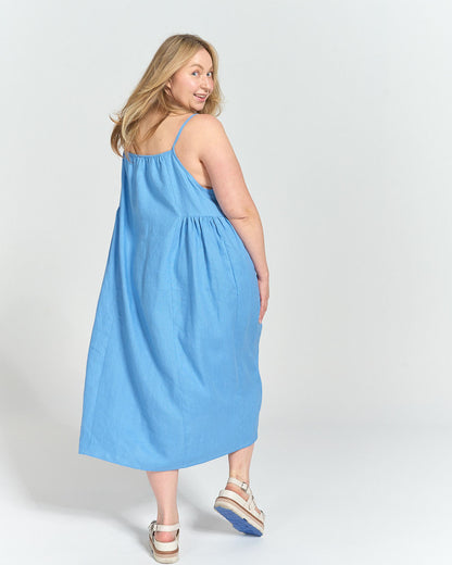 Model twirling in the finished sundress in blue linen 