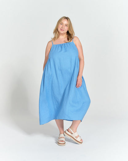 Model wearing Schoolhouse Sundress made in light blue Cloud Linen with gathered neckline and spaghetti straps