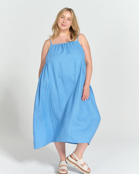 Model wearing Schoolhouse Sundress made in light blue Cloud Linen with gathered neckline and spaghetti straps