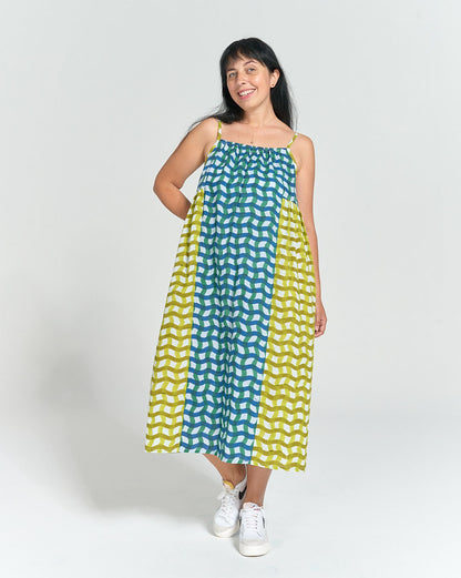 Model wearing Schoolhouse Sundress made in yellow and blue bock print cotton with gathered neckline and spaghetti straps